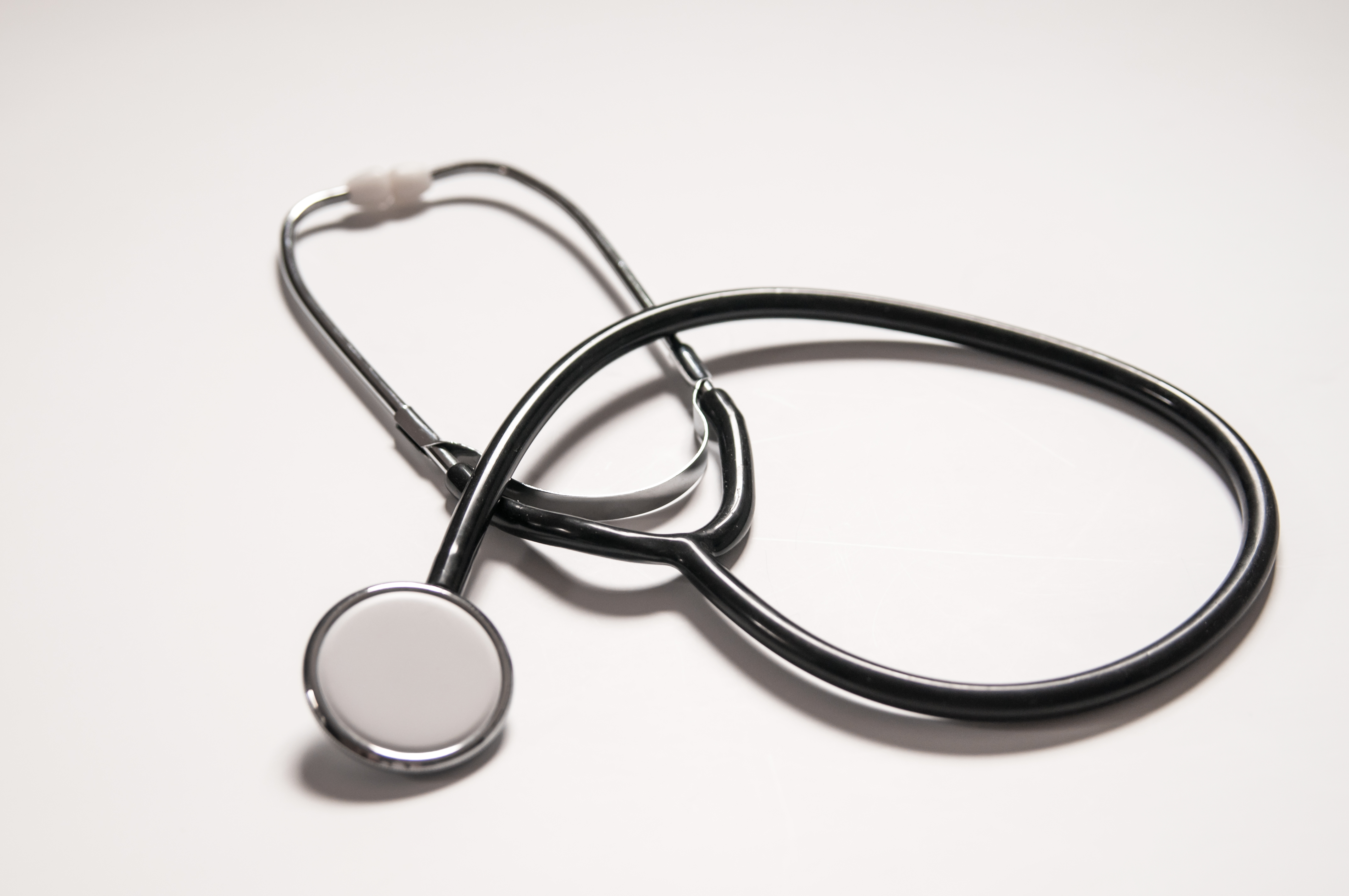 Close up view of black stethoscope on white back